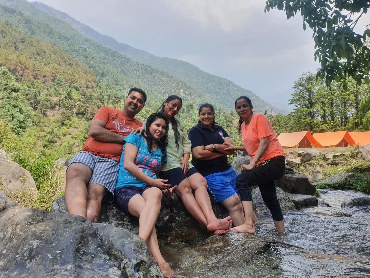 A small Wings and Wheels group resting beside a mountain river