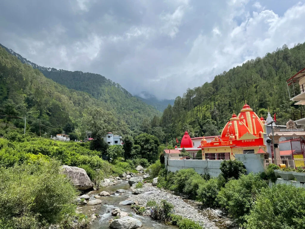 Kainchi Dham temple surrounded by green Himalayan hills